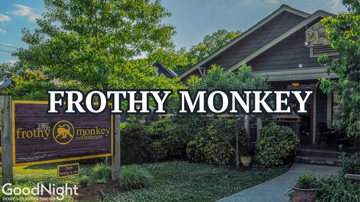 The exterior of Frothy Monkey café, with its prominent sign, inviting garden area, and the building’s welcoming façade. The casual outdoor seating suggests a sociable spot to savor coffee and pastries, echoing the local café culture.